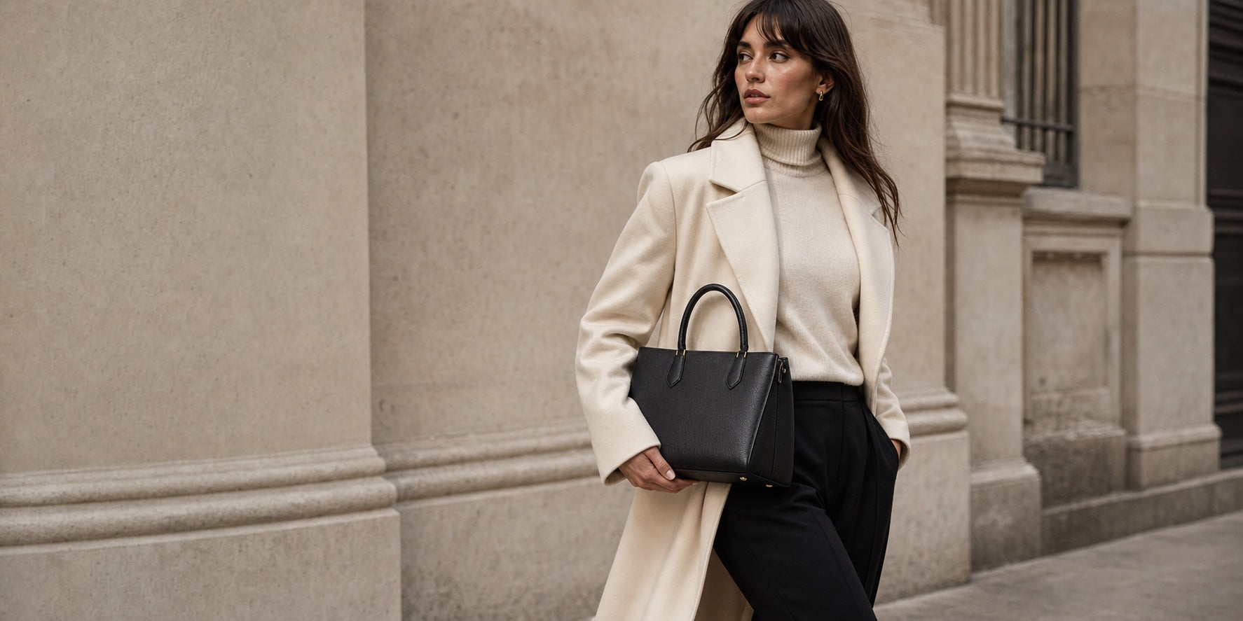 Woman styling a black Maison top handle bag