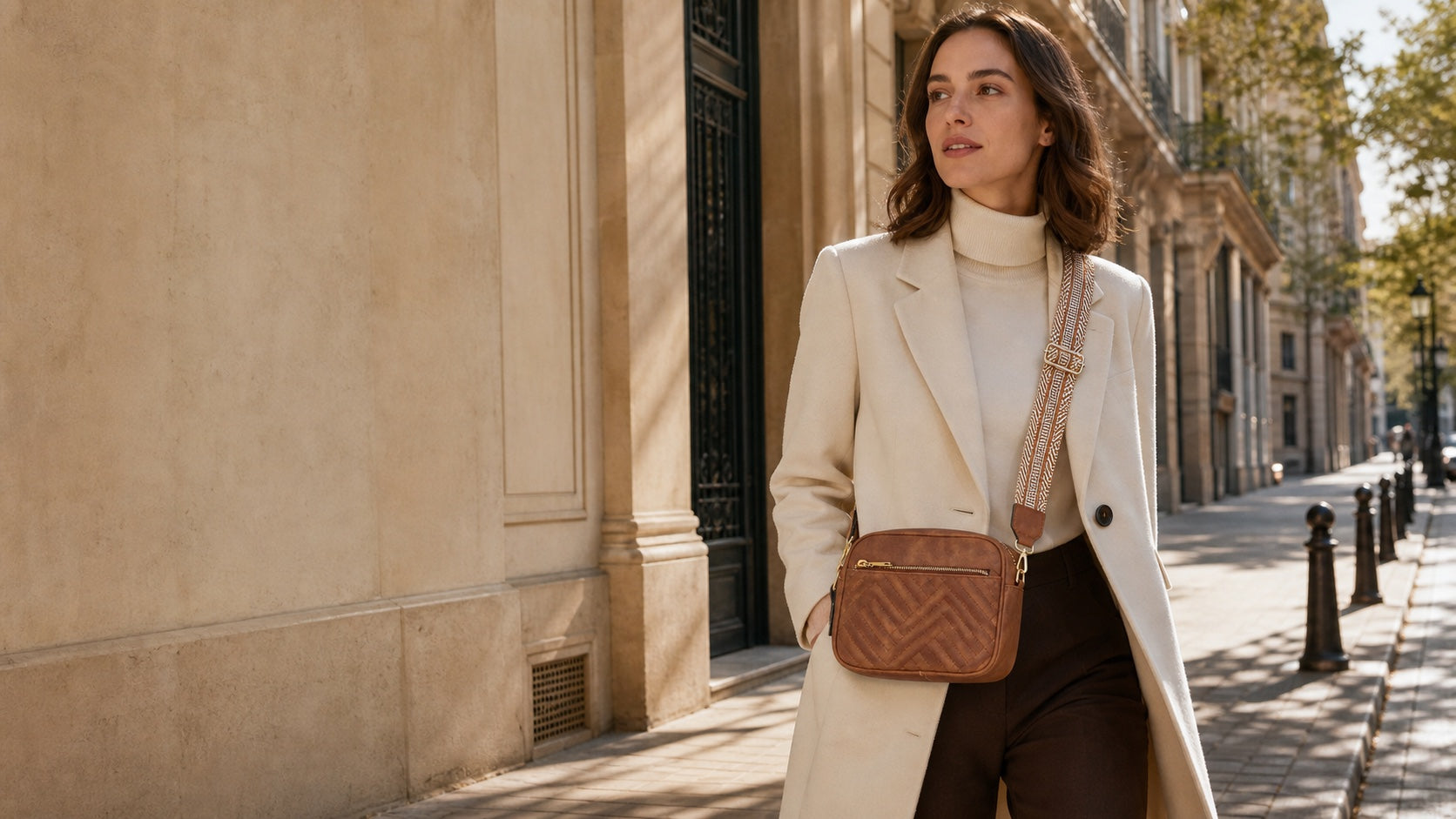 Woman styling the Noa cognac crossbody on a European street